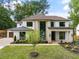 Stunning two-story home with a white exterior, stone accents, and lush landscaping, offering curb appeal at 401 Lynne Cir, Alpharetta, GA 30009