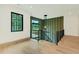 Upstairs landing with modern railings and a view of the lush, green backyard at 401 Lynne Cir, Alpharetta, GA 30009