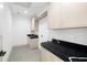 Well-organized laundry room featuring ample counter space and cabinetry, complete with stylish finishes at 401 Lynne Cir, Alpharetta, GA 30009