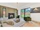 Modern living room with a black marble fireplace, large windows, and plush seating at 401 Lynne Cir, Alpharetta, GA 30009