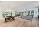 Open-concept living area showcasing hardwood floors, dining table, and seamless flow to the kitchen at 401 Lynne Cir, Alpharetta, GA 30009