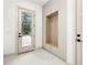Mudroom featuring built-in storage, coat hooks, and a glass panel door with natural light at 401 Lynne Cir, Alpharetta, GA 30009