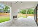 Covered patio featuring a white brick fireplace and ample space for outdoor entertaining at 401 Lynne Cir, Alpharetta, GA 30009