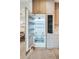 Modern refrigerator with stainless steel interior and custom paneling for seamless kitchen design at 401 Lynne Cir, Alpharetta, GA 30009