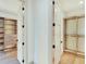 Spacious walk-in closet with bright lighting, custom shelving, and mirrored doors at 401 Lynne Cir, Alpharetta, GA 30009