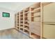 Bright walk-in closet with custom built-ins, ample shelving, and hardwood floors at 401 Lynne Circle, Alpharetta, GA 30009