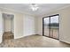 Bright bedroom with wood-look floors, ceiling fan, and sliding door to outdoor deck at 1729 James Burgess Rd, Suwanee, GA 30024