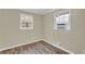 Bedroom features wood look floors, neutral walls, and bright windows at 1729 James Burgess Rd, Suwanee, GA 30024
