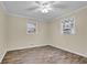 Bedroom features wood look floors, neutral walls, and a ceiling fan at 1729 James Burgess Rd, Suwanee, GA 30024
