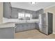 Modern kitchen showcasing stainless steel appliances, neutral countertops, and ample cabinet space at 1729 James Burgess Rd, Suwanee, GA 30024