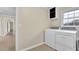 Laundry room with a front load washing machine, dryer and tile flooring at 1729 James Burgess Rd, Suwanee, GA 30024