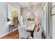 Open dining room area featuring wainscotting and a designer chandelier at 303 Mountain Brook Rd, Cumming, GA 30040