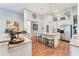 Bright kitchen with island seating, stainless appliances, white cabinets, wood floors, and modern lighting at 303 Mountain Brook Rd, Cumming, GA 30040