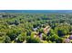 Aerial view of a residential neighborhood surrounded by lush, mature trees, showcasing a serene setting at 7215 Gresham Trce, Cumming, GA 30040