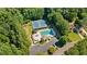 Aerial view of the community pool, tennis courts, and surrounding lush greenery for a recreational lifestyle at 7215 Gresham Trce, Cumming, GA 30040