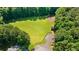 Aerial view of a community field, basketball court, and surrounded by lush greenery for a recreational lifestyle at 7215 Gresham Trce, Cumming, GA 30040