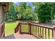 Lovely backyard view from the deck with green grass and mature trees at 7215 Gresham Trce, Cumming, GA 30040