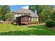 Expansive backyard with lush green lawn and a screened porch perfect for outdoor enjoyment at 7215 Gresham Trce, Cumming, GA 30040