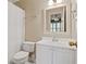 Bright bathroom featuring a white vanity, toilet, and shower with patterned curtain at 7215 Gresham Trce, Cumming, GA 30040