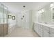 Bright bathroom with double vanity, soaking tub, and separate shower, providing a spa-like experience at 7215 Gresham Trce, Cumming, GA 30040