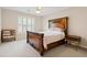 Bedroom featuring a wooden bed, carpet, ceiling fan and a window offering natural light at 7215 Gresham Trce, Cumming, GA 30040