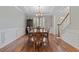 Well-appointed dining room with hardwood floors, decorative trim, and a view to the staircase at 7215 Gresham Trce, Cumming, GA 30040