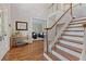 Elegant foyer with hardwood floors and staircase leading to the upper level, welcoming guests at 7215 Gresham Trce, Cumming, GA 30040