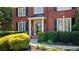 Close-up of the home's entrance, showcasing the brick facade and well-maintained landscaping at 7215 Gresham Trce, Cumming, GA 30040