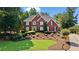 Inviting red brick two-story home with manicured lawn and charming curb appeal at 7215 Gresham Trce, Cumming, GA 30040