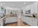Well-lit kitchen with white cabinets, granite countertops, and stainless steel appliances at 7215 Gresham Trce, Cumming, GA 30040