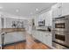 Modern kitchen with white cabinetry, stainless steel appliances, and granite countertops at 7215 Gresham Trce, Cumming, GA 30040