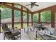 Cozy screened-in porch with comfortable seating, perfect for relaxing and enjoying the outdoors at 7215 Gresham Trce, Cumming, GA 30040