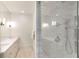 Modern bathroom features a glass enclosed shower with tiled walls, shower niche, and updated fixtures at 2500 Peachtree Nw Rd # 606N, Atlanta, GA 30305