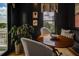 Cozy breakfast nook featuring dark walls, a wood table, cushioned seating, and a large potted plant at 2500 Peachtree Nw Rd # 606N, Atlanta, GA 30305