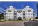 A luxurious condominium building featuring a porte cochere, circular driveway, and manicured landscaping at 2500 Peachtree Nw Rd # 606N, Atlanta, GA 30305