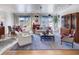 A traditionally styled living room with hardwood floors, a blue rug and access to the dining area at 2500 Peachtree Nw Rd # 606N, Atlanta, GA 30305
