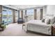 Bright main bedroom features many windows, neutral color palette and access to the balcony with city views at 2500 Peachtree Nw Rd # 606N, Atlanta, GA 30305