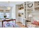 Home office featuring a large desk, custom built-ins, and an eclectic mix of decor and seating at 2500 Peachtree Nw Rd # 606N, Atlanta, GA 30305