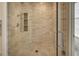 Tiled shower with glass doors, shower niche, rainfall shower head, and handheld wand for added convenience at 2500 Peachtree Nw Rd # 606N, Atlanta, GA 30305