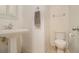 Bright powder bathroom featuring a pedestal sink, toilet, towel rack, and neutral walls at 1530 Oakview Rd, Decatur, GA 30030