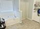 Relaxing bathroom with a large soaking tub and bright natural light at 204 Hightower Trl, Riverdale, GA 30274