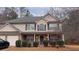 Charming two-story home with a covered front porch and well-maintained landscaping at 204 Hightower Trl, Riverdale, GA 30274