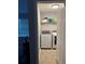 Bright laundry room with side by side washer and dryer and overhead shelving at 204 Hightower Trl, Riverdale, GA 30274