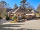 Brick Tudor-style house featuring an outdoor seating area and gated driveway at 549 Lakeshore Ne Dr, Atlanta, GA 30307