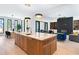 Open floor plan shows the kitchen island, dining area, and living room with fireplace and built-in bookshelves at 391 Lynne Circle, Alpharetta, GA 30009