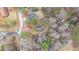 An aerial view of a home surrounded by tall trees and adjacent to a quiet neighborhood street at 80 Holder St, Temple, GA 30179