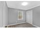 A bedroom with gray walls, new hardwood floors, and a window at 80 Holder St, Temple, GA 30179