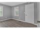 A bedroom with gray walls, new hardwood floors, and a closet at 80 Holder St, Temple, GA 30179