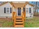 Inviting front porch with wooden steps and railings, leading to a charming one-story home at 80 Holder St, Temple, GA 30179
