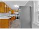 Galley kitchen with stainless steel appliances, white counters, and warm wood cabinets at 80 Holder St, Temple, GA 30179